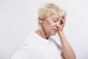 Portrait of a woman experiencing a migraine