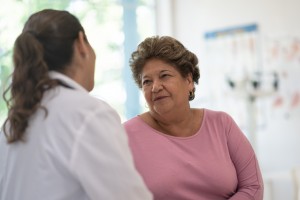 Hispanic senior speaking with doctor