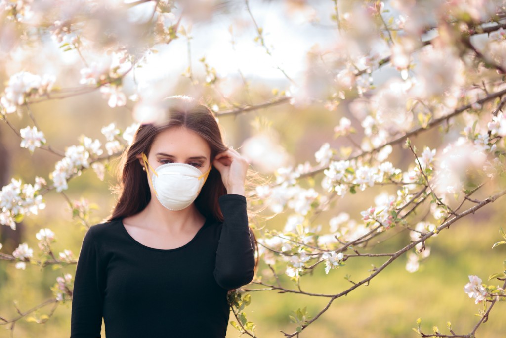 Woman with Respirator Mask Fighting Spring Allergies or COVID-19