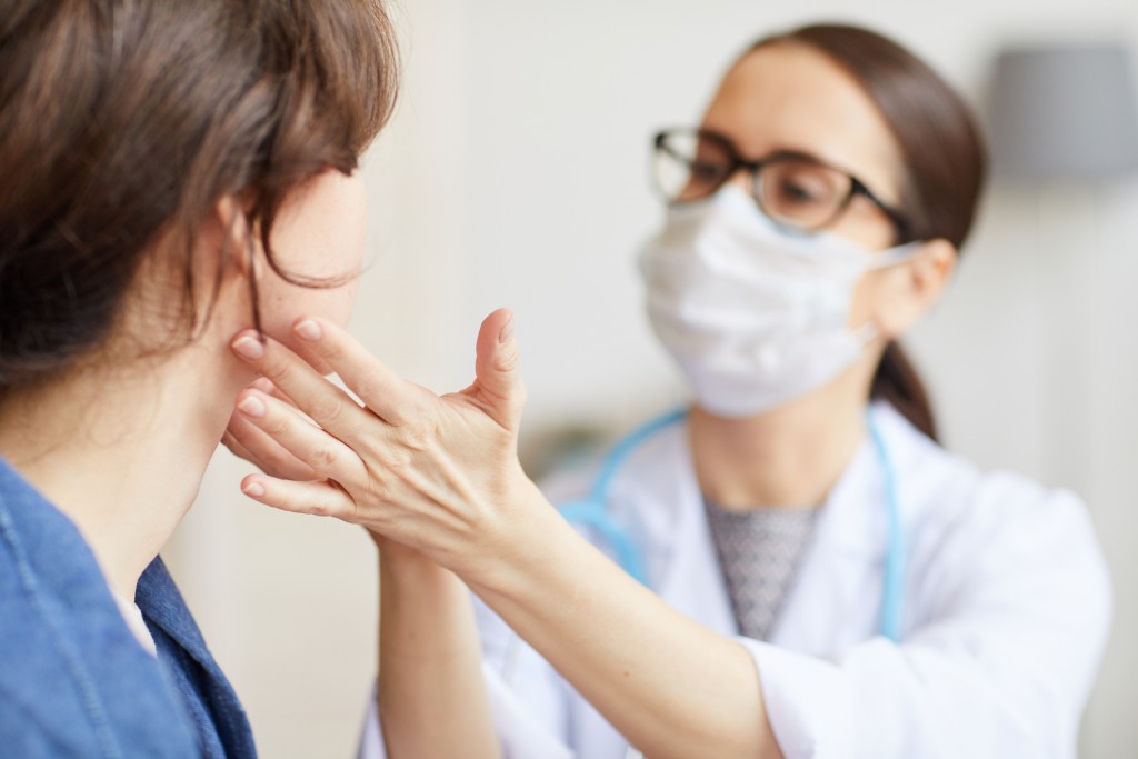 Doctor giving patient a physical exam