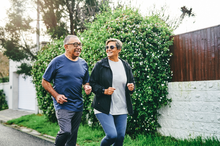 Senior hispanic couple staying active on a jog.  